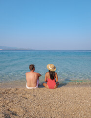 Relaxing by the tranquil waters of Brac Island, Croatia, under a clear blue sky