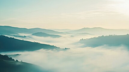 Obraz premium A tranquil landscape covered in a thick sea of fog with rolling hills in the distance, providing ample open space for text.