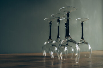 Empty glasses turned upside down on a wooden surface, representing a deliberate choice against alcohol consumption.