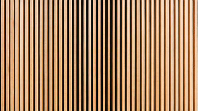 Wall made of wooden panels. Vertical wooden slats for facade cladding. Timber stripes made of beige pine. A modern plank surface for interior and exterior design.