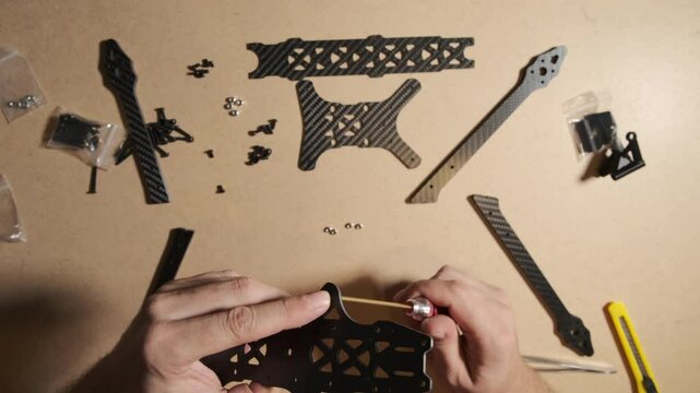 FPV drone quadcopter frame assembly at home. Modern weapon crafted by an enthusiast volunteer in Ukraine.