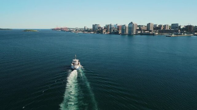 Watch As The Halifax Ferry Glides Across The Water With The City Skyline And Harborfront Of Halifax Creating A Stunning Scene. The Oldest Ferry Route In North America. Halifax, Nova Scotia, Canada 