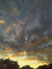 A bright sunset with large rain clouds in the sky. Evening sunrise and sunset in the background
