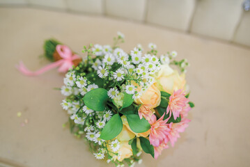Wedding bouquet. Beautiful multi colored fresh flower arrangements. wedding day. The bride and groom were photographed on the sofa.