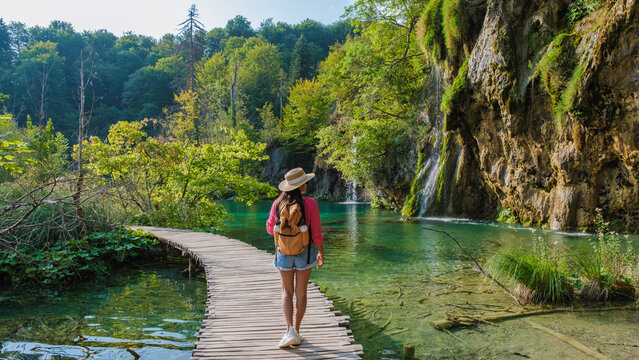 A tranquil stroll along the wooden paths of Plitvice Lakes in Croatia, surrounded by nature's beauty