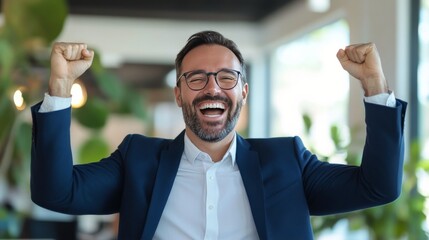 Fototapeta premium A man celebrating his success at a modern office during a bright afternoon