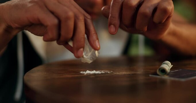 Drugs, addiction and hands of person with powder, card and dollar bill for narcotics on table at night. Danger, mental health and cocaine with fentanyl risk, substance abuse and opioid crisis in home
