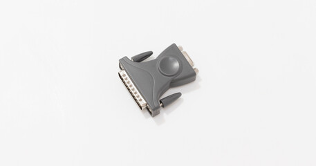 A close up of gray electronic adapter with DB25 and DB9 connector on white background.
