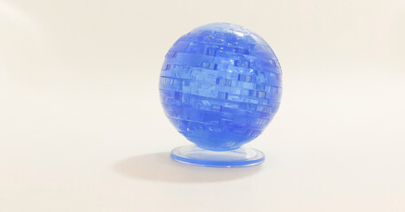 Transparent blue spherical puzzle toy on white background, showcasing layered design and intricate internal structure.