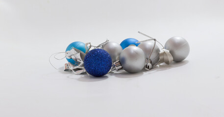 Blue and silver Christmas ornaments scattered on plain surface, perfect for holiday themed projects...