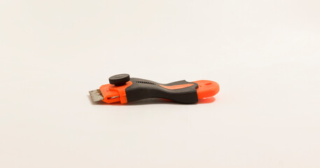 Compact handheld scraper tool with an ergonomic design and visible blade, ideal for precise scraping tasks.