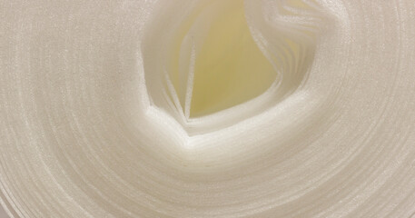 Obraz premium A close up view of rolled foam material with soft texture and gentle light, creating abstract patterns.