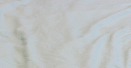 A subtle abstract texture of soft, crumpled white fabric, evoking gentle, serene atmosphere.