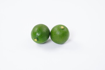 Lime fruit. Fresh, tangy lime with bright green skin and juicy interior. Ideal for culinary, healthy, and citrus-themed visuals. Ripe lime fruits with slices isolated on a white background.