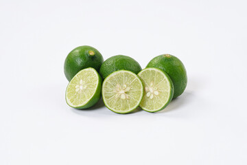Lime fruit. Fresh, tangy lime with bright green skin and juicy interior. Ideal for culinary, healthy, and citrus-themed visuals. Ripe lime fruits with slices isolated on a white background.