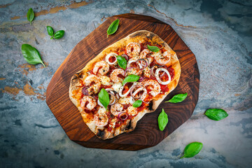 Traditional Italian pinsa bread prosciutto e salsa di pomodoro with seafood, buffalo mozzarella and...