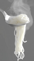 Tender, steaming noodles gracefully hang from a silver spoon, emitting wisps of steam that enhance the cozy atmosphere, inviting all to indulge in a delicious meal
