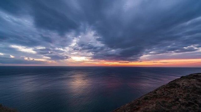 Timelapse of sunset on sea with clouds. Fast time movement