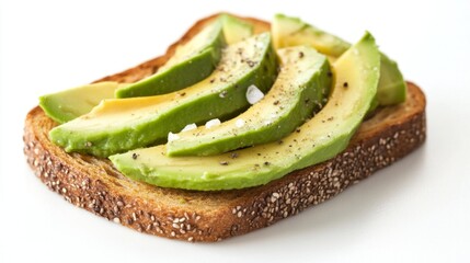 A close-up of a slice of golden-brown toast topped with creamy avocado and a sprinkle of salt, set against a bright white background, highlighting a healthy breakfast option.