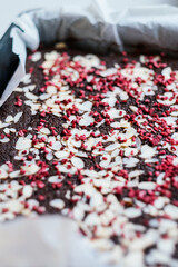 brownie cake with almond slices and lyophilized raspberries