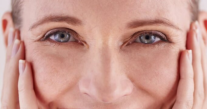 Beauty, eyes and wrinkles with mature woman closeup in studio for cosmetic skincare treatment. Face, smile and zoom with person at salon or spa for antiaging collagen, dermatology or wellness