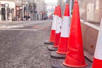 Traffic cones stand in a row on an asphalt road. Devices for temporary marking of roads. Avriynye...