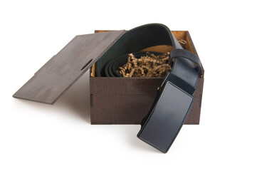 Black leather belt twisted into a ring, packing wooden box