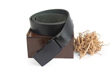 Black leather belt twisted into a ring, packing wooden box