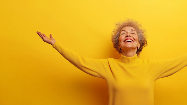 A joyful elderly woman with light brown skin, her arms spread wide in greeting, isolated on a soft pastel yellow background, her face glowing with warmth and friendliness.