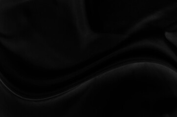 Black gray satin dark fabric texture luxurious shiny that is abstract silk cloth background with patterns soft waves blur beautiful.