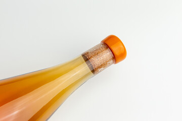 Close-Up of Sealed Orange-Capped Bottle Against White Background.  Ideal for beverage, packaging, and minimalist concepts.