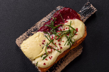 Delicious sweet brioche sandwich with raspberry jam and ricotta cream