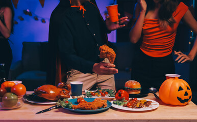 Joyful office Halloween party with coworkers in costumes, celebrating with drinks and laughter, fostering teamwork and festive spirit