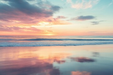 Obraz premium Sunset Reflection on Calm Ocean Waves and Sandy Beach