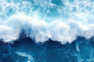 Fototapeta premium blue water with white wave splash taken by drone shot on a beach