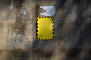 Yellow caution sign on a distressed urban wall