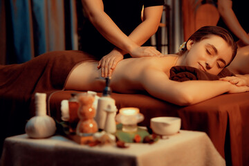 Caucasian couple customer enjoying relaxing anti-stress spa massage and pampering with beauty skin...