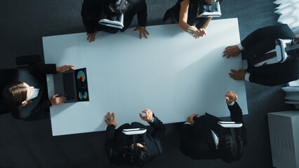 Top down aerial view of professional business team wear vr headset to enter virtual world while sitting and using hand gestures to manipulate the data from the manager laptop. Technology. Directorate.