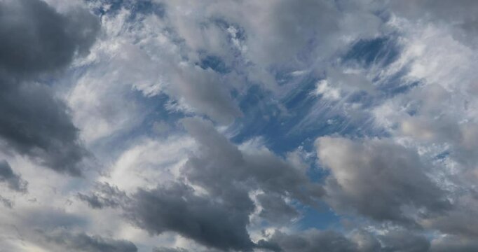 Two direction moving clouds on two layers in the cold morning autumn sky. 