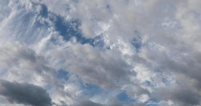 Two direction moving clouds on two layers in the cold morning autumn sky. 