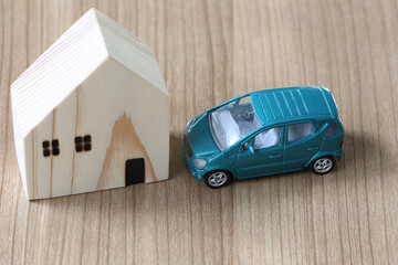 Miniature Car and House on Wooden Surface