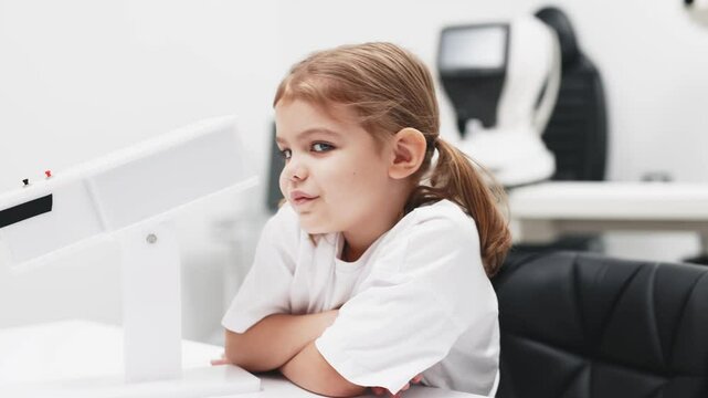 A young girl engages in orthoptic and pleoptic therapy using advanced vision stimulation equipment. Laser eye treatment promotes recovery and enhances vision in a soothing environment.