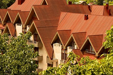 Residential building with a peaked roof, surrounded by trees