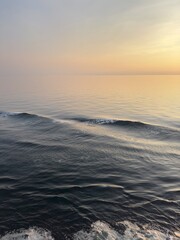 Beautiful waves in calm seas with the sun setting