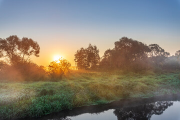A beautiful, serene landscape with a sun setting in the background