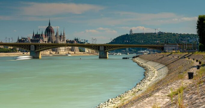 Budapest, Hungary - August 09, 2024: Cityscape view from Slachta Margit street. Parliament building on the background. Time-lapse.