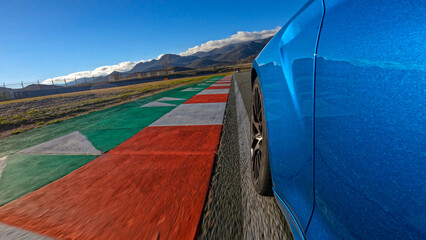LOW ANGLE, CLOSE UP: Action shot of a brand new luxury car racing on a closed circuit on a perfect...