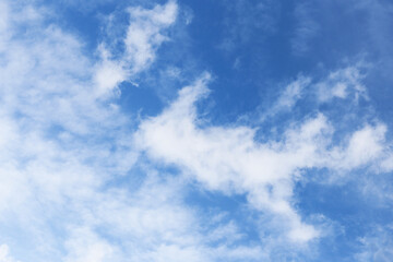 Blue sky background with soft clouds. Serene and relaxing nature scene. Perfect sky for a peaceful and calm atmosphere. Puffy white clouds. Tranquility and paradise.