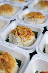 Boxed rice. Rows of packaged rice boxes, spicy seasoned shredded chicken.