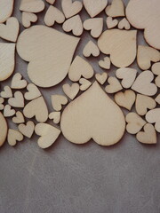Obraz premium valentine's day greeting card-wooden hearts on a gray suede background. High quality photo